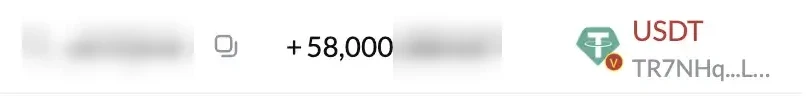 Part of a blockchain explorer row with an incoming transfer of 58,000 USDT. The wallet address and the exact amount are blurred.